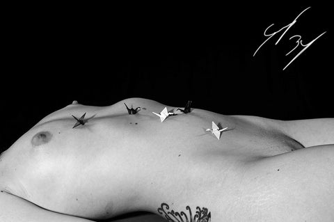 Nude model with paper cranes